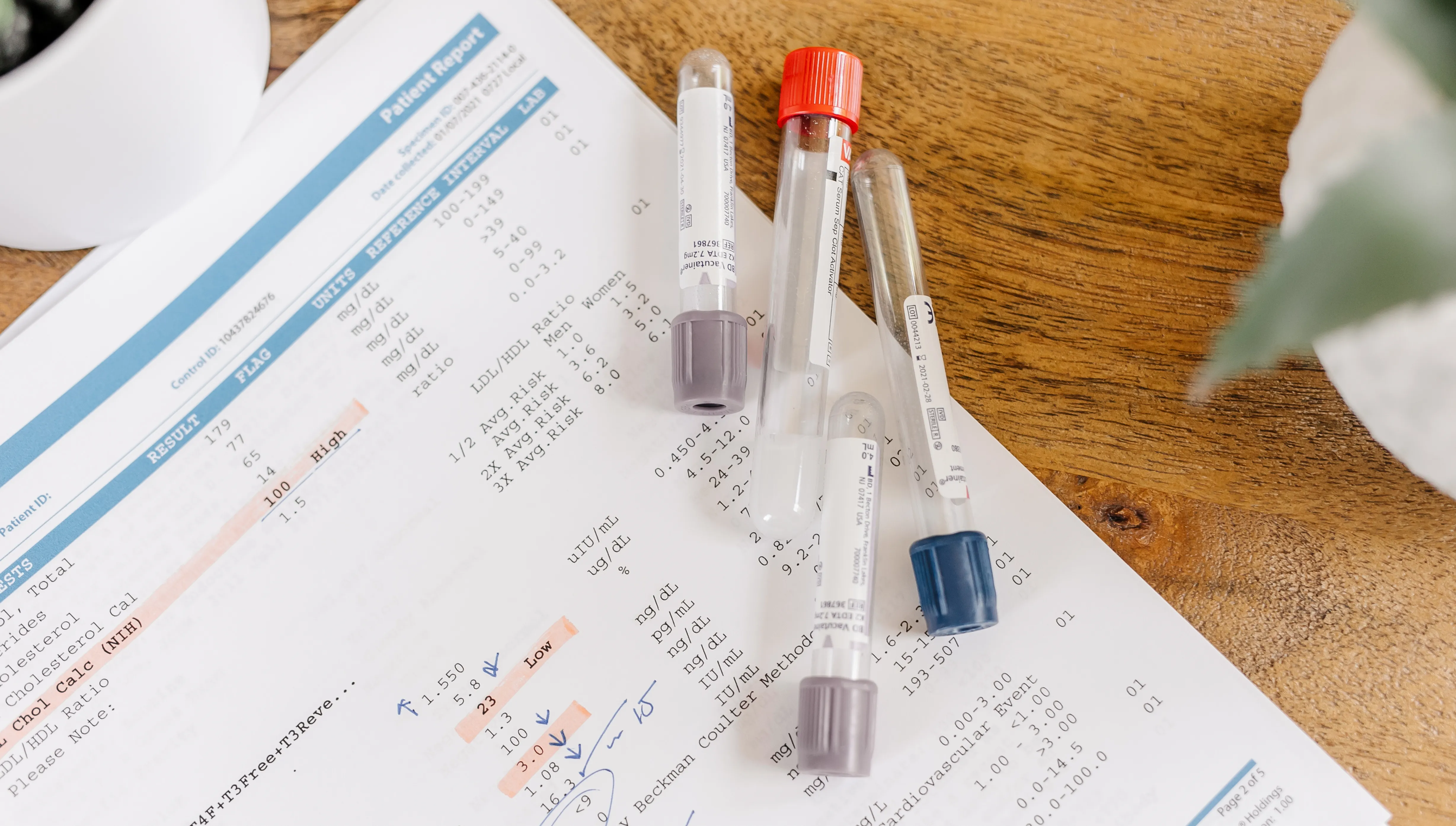 Blood-collection tubes on an annotated lab report