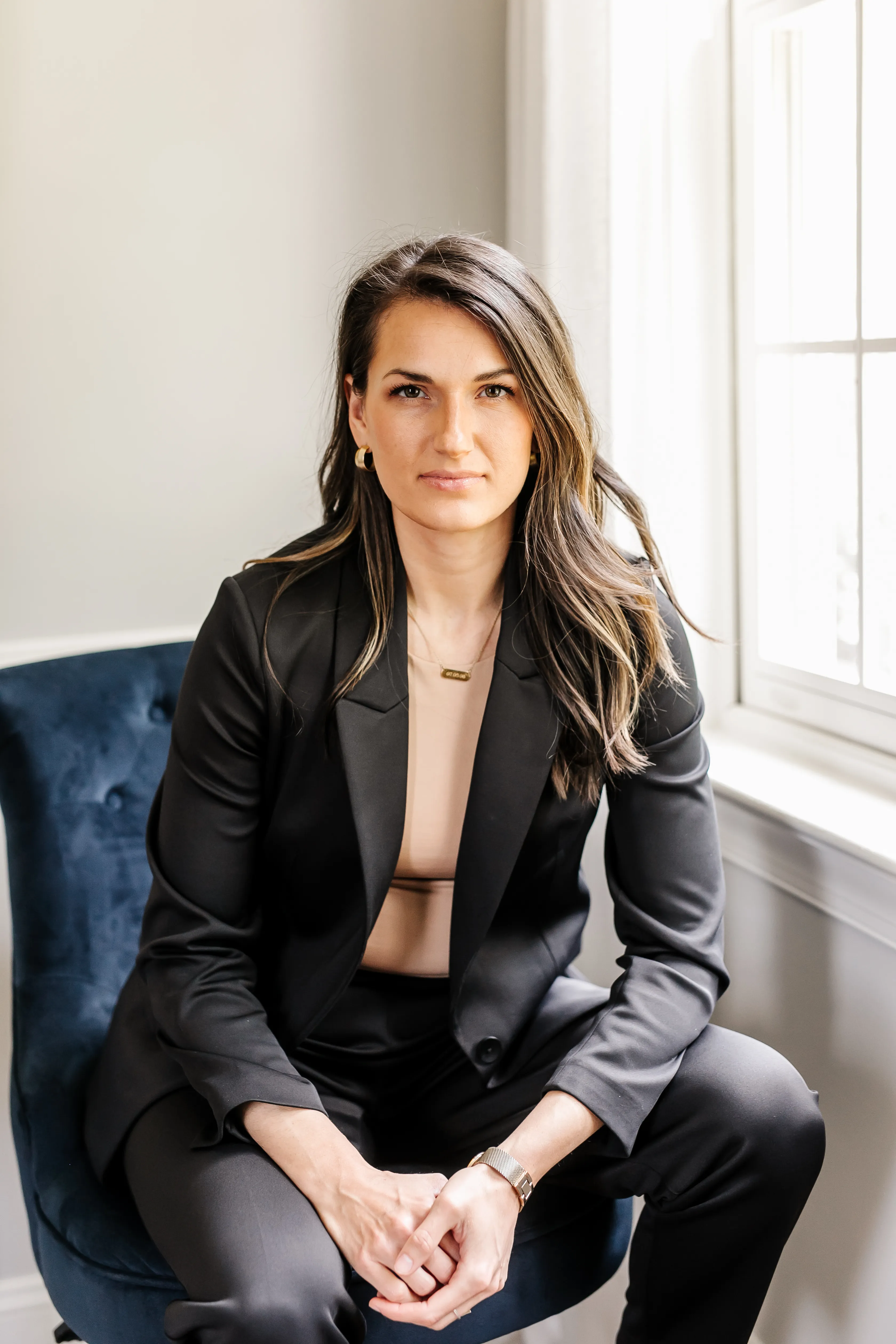 Dr. Abigail Vermeesch seated, composed and professional